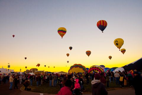 hot air balloons taking off at dawn
