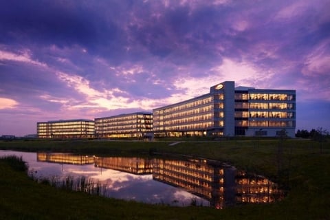 Large office building overlooking water at night