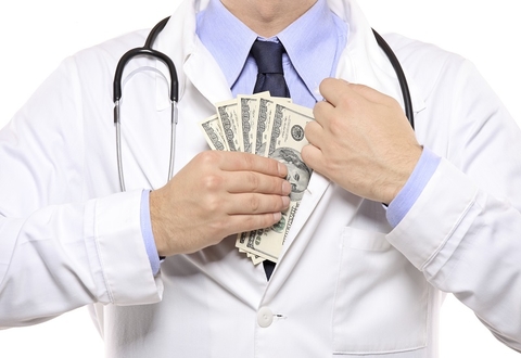 Man putting money into white doctor's coat