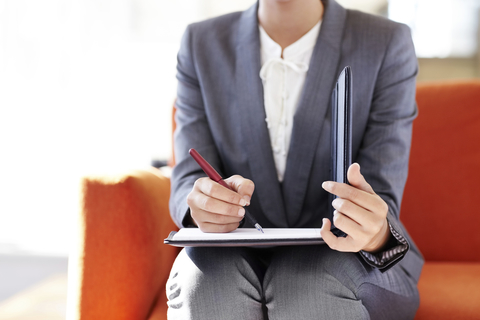 Photo of a young businessperson taking notes