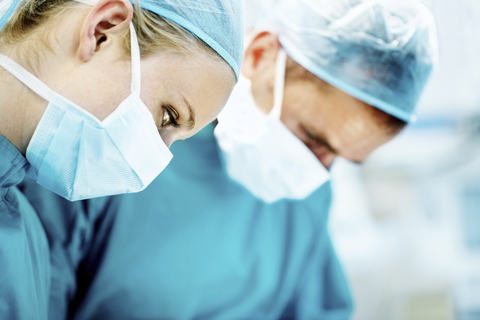 Two doctors conducting surgery