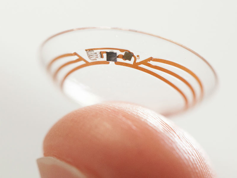 finger holding contact lens