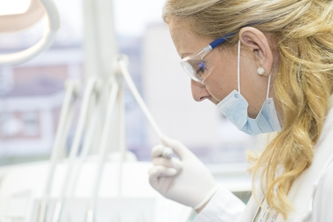 Female doctor performing a procedure.