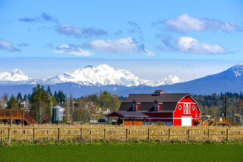 Farm scene with mountains in the background