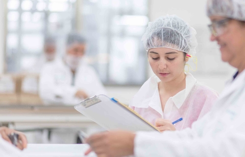 researchers looking at a clipboard in a laboratory