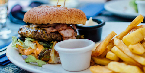 A cheese burger and french fries on a plate