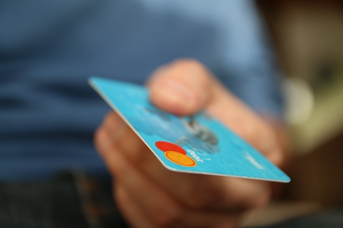 closeup of a person holding a credit card