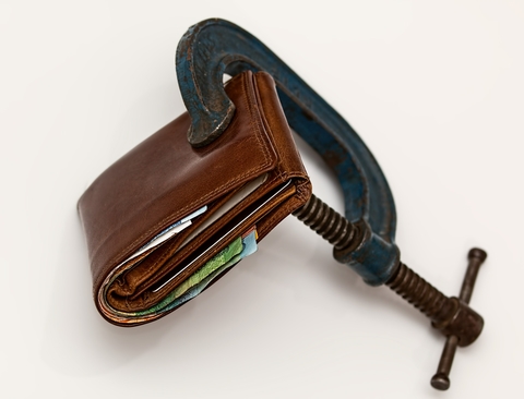 A vice squeezing a wallet