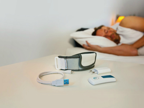 sleeping man and woman with device in foreground