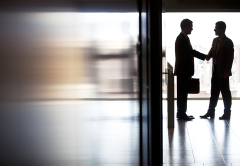 Business shaking hands deals M&A CREDIT: Getty/Sam Edwards Two businessmen shaking hands in a hallway