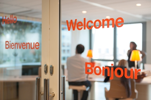 Orange office glass office doors with a welcome message