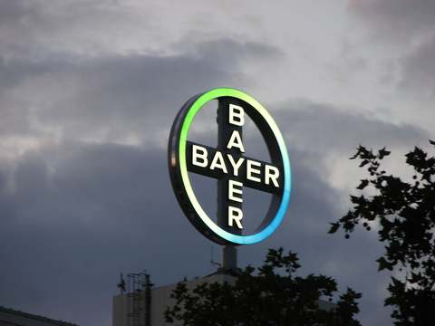 Bayer logo and dark clouds Bayer logo and dark clouds
