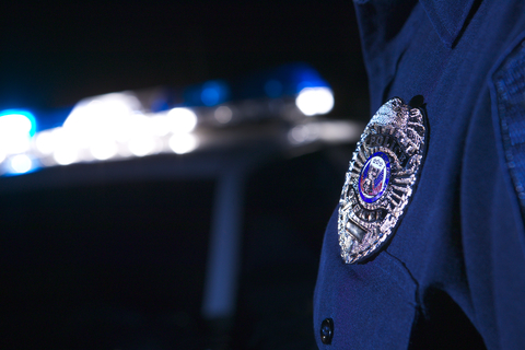Police badge (Getty/Thinkstock) Closeup of police officer's badge with car in background
