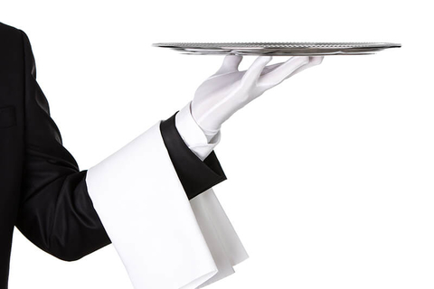 Waiter holding silver platter - Nastco/iStock/Getty Images Plus/Getty Images