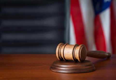Gavel flag courtroom Gavel and flag in courtroom