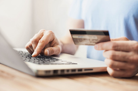 Credit Card Online Shopping Getty Young man shopping with credit card and laptop computer