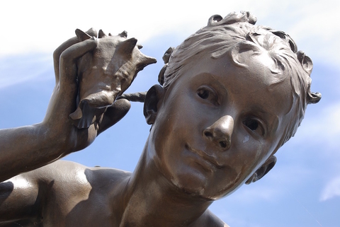 statue-hearing statue holding a shell to ear
