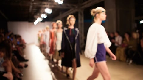 Models walk down a runway at New York Fashion Week