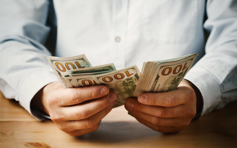 compensation salary money man counting money