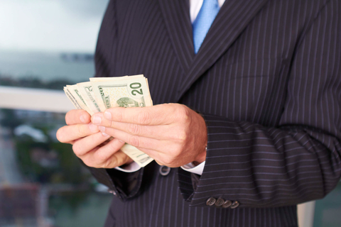 Executive pay Businessman holding money
