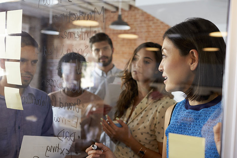 Millennials Working Credit monkeybusinessimages iStock Getty Images Plus Getty Images Businesswoman Writing Ideas On Glass Screen During Meeting