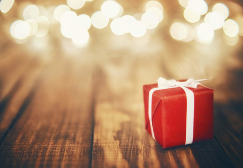 Red gift box with white ribbon Red present on wood background