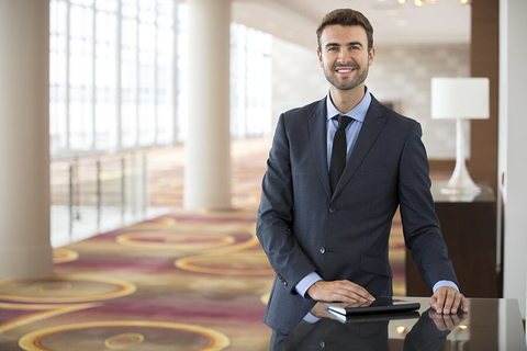 Hotel salesperson Man standing in a hotel public space