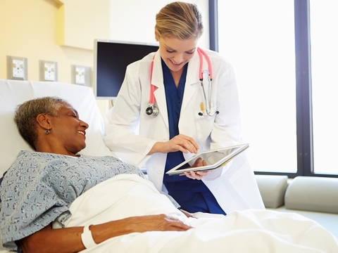 Bedside tablet (Getty/monkeybusinessimages) Woman showing a patient in bed a tablet computer