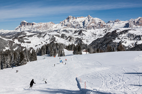 Alta Badia Dolomites Italy // Photo by bukki88/iStock/Getty Images Plus/Getty Images Skiers going down a mountain in Alta Badia Dolomites Italy