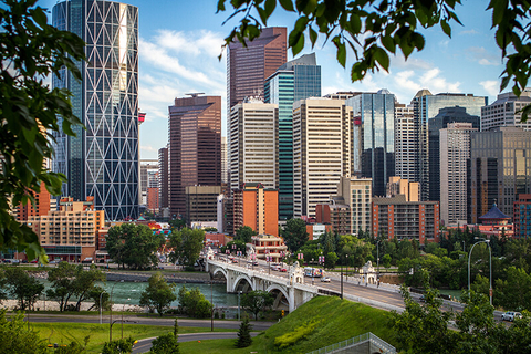 Calgary, Canada // Photo by daniel50/iStock/Getty Images Plus/Getty Images the Calgary, Canada skyline through the trees