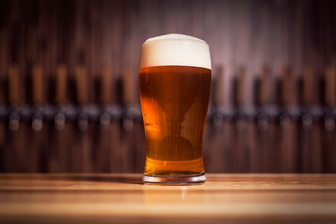 beer // Photo by dor-riss/iStock/Getty Images Plus/Getty Images beer with foam on a bar counter
