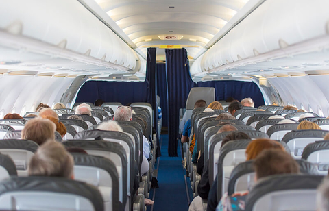 Airplane cabin with passengers - AlxeyPnferov/iStock/Getty Images Plus/Getty Images Airplane cabin with passengers