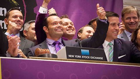 Planet Fitness CEO Chris Rondeau center in purple shirt and tie gives a thumbs up during the company39s initial public offering at the New York Stock Exchange on Aug 6 Photo courtesy Planet Fitness