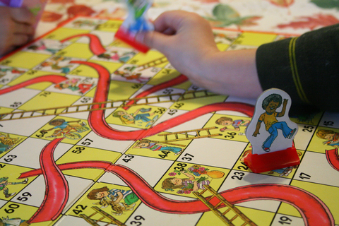 Chutes and Ladders Board game with pieces on it