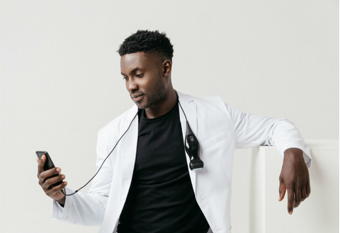 butterfly network iQ Doctor holding iphone and iQ ultrasound device