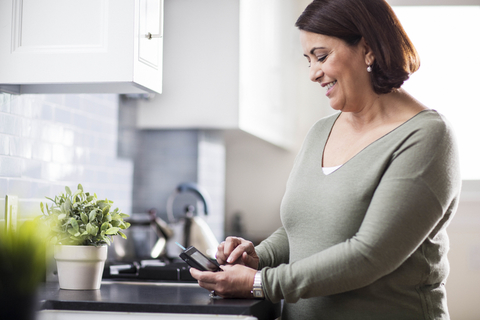 Woman using Livongo diabetes meter Woman using Livongo diabetes meter