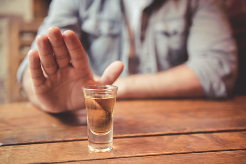 Man refusing a shot of alcohol Man saying no to alcohol