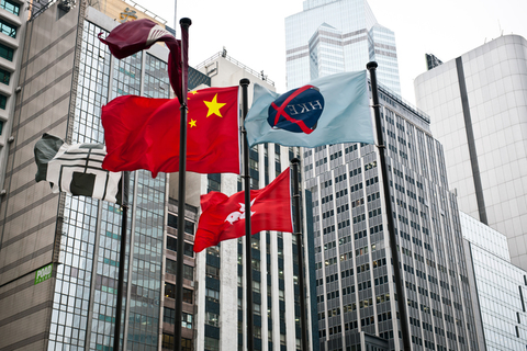 Flags in front of HK stock exchange Facade of HKSE