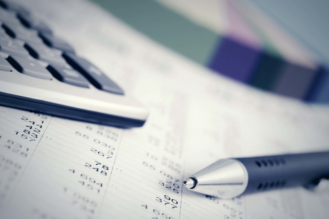 Financial accounting paperwork calculator and pen Profits and loss document with calculator and pen