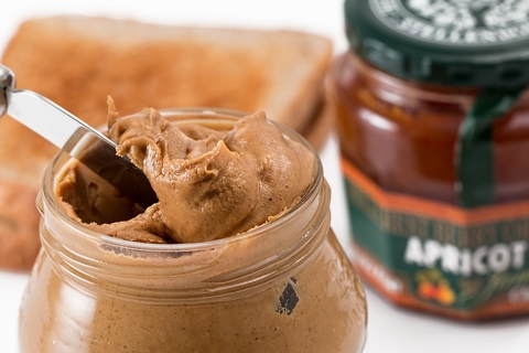peanut butter toast with peanut butter and jam jar