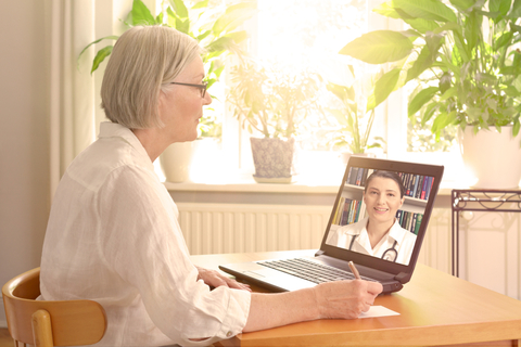 Medicare telehealth senior woman in front of laptop during virtual visit with doctor