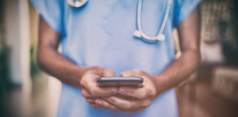doctor using smartphone doctor in hospital hallway using smartphone