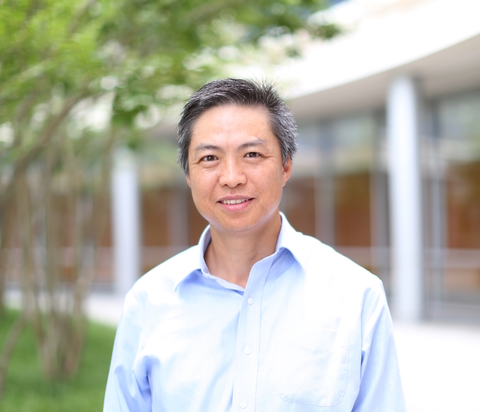 Viela Bio CEO Bing Yao standing outside against an unfocused backdrop of trees and a building