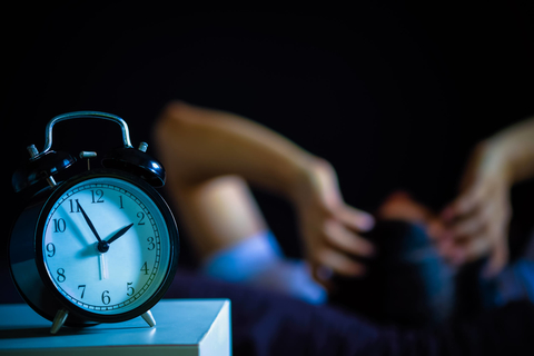Man in bed suffering insomnia and sleep disorder Man with insomnia in bed