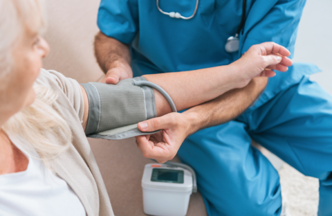 Blood pressure Doctor taking blood pressure of an older patient