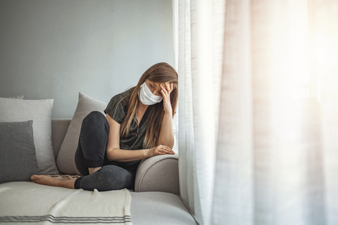 COVID-19 behavioral health mental health A woman in a face mask appears upset