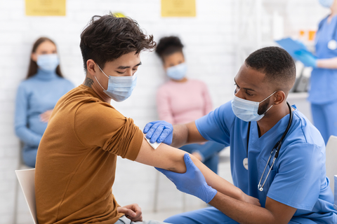 Covid Vaccine image Man Receiving Coronavirus Vaccine Injection During Appointment In Hospital