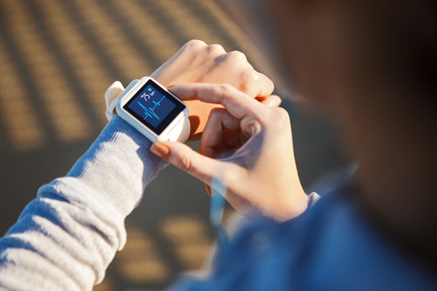 Smart watch showing heart rate results Smart watch on runner's wrist showing heart rate results