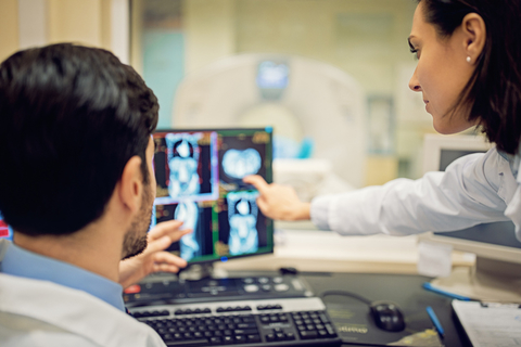 CT scan oncology Two doctors examine a CT scan