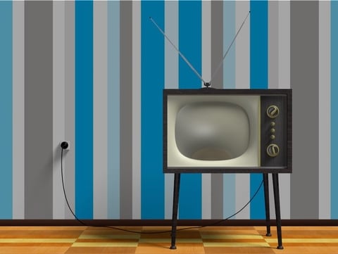 1960s-era TV with rabbit antenna against blue stripe wallpaper